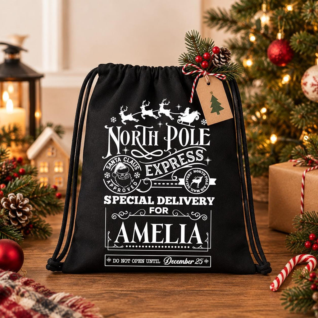 A black drawstring bag with a Christmas-themed design, featuring text and illustrations related to the North Pole Express special delivery service.